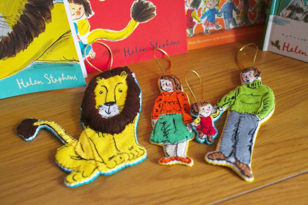 Photograph of three hand-made decorations presented in front of children's books written by author Helen Stephens.